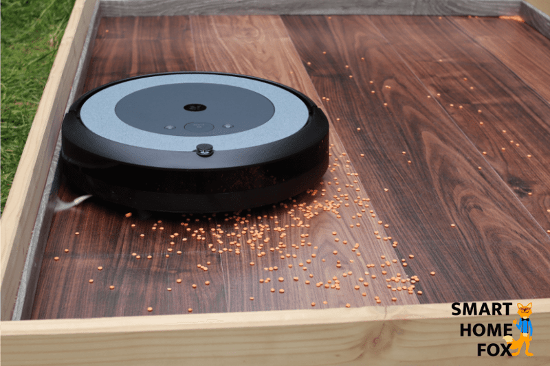 Vacuum cleaner robot cleans along a skirting board.